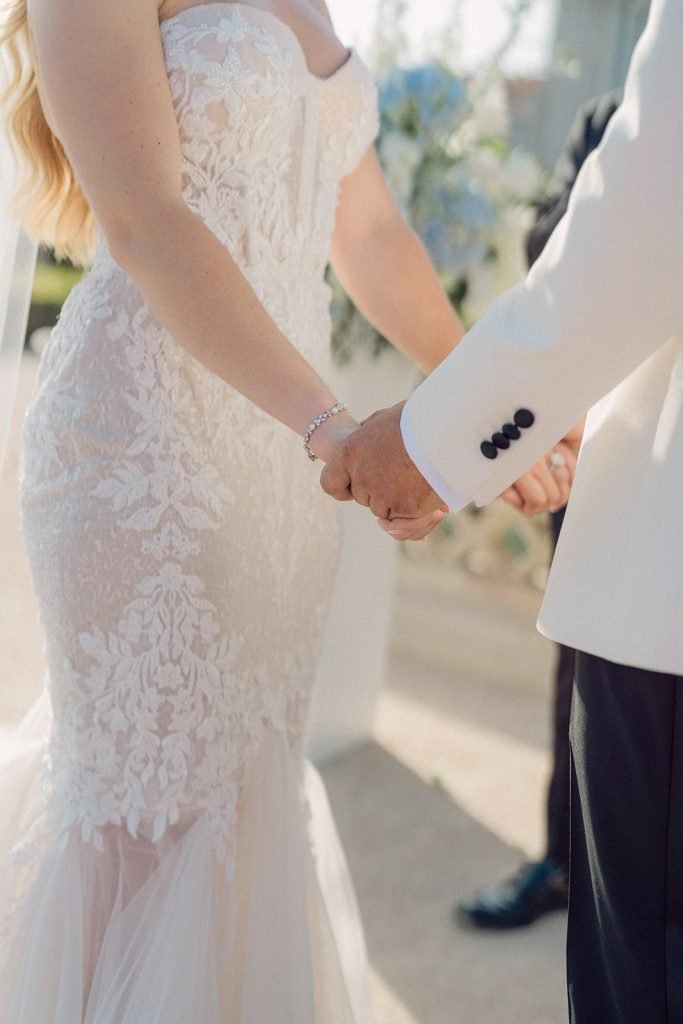 Couple holding hands during ceremony at Queluz Palace
