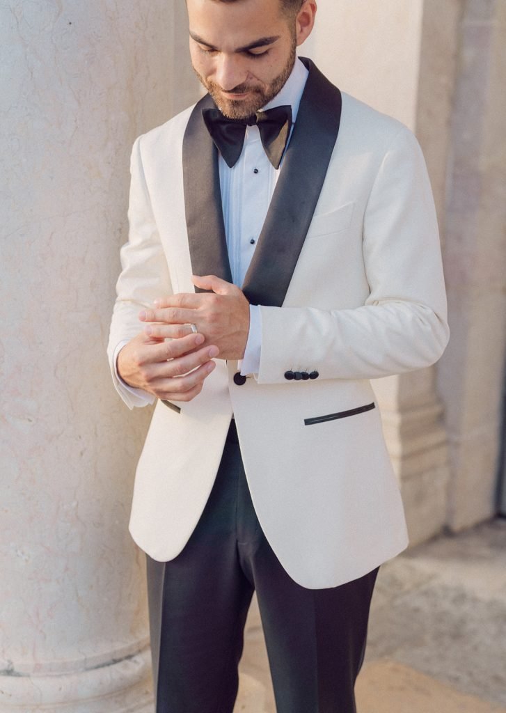 Groom adjusting jacket before ceremony at Lisbon palace wedding