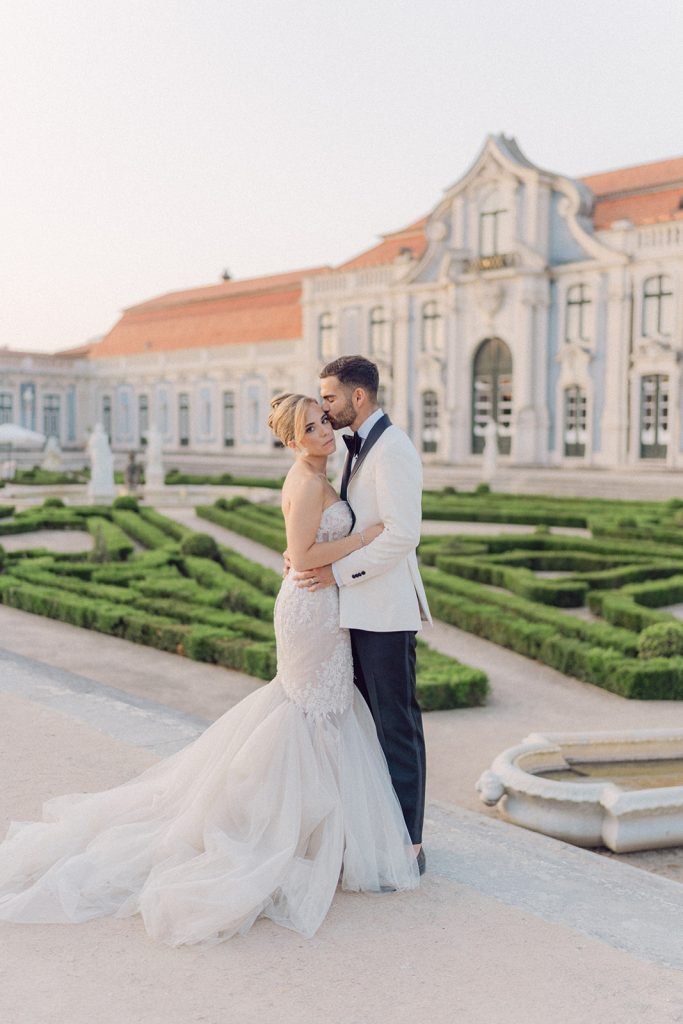 Bride and groom in historic palace setting in Portugal