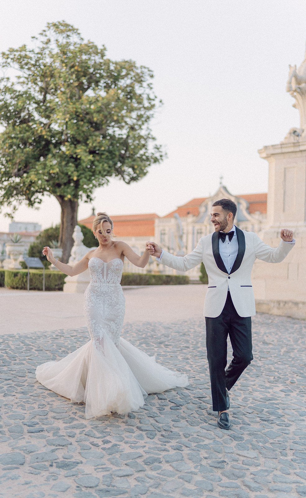 A newly married couple celebrating together outside their wedding venue