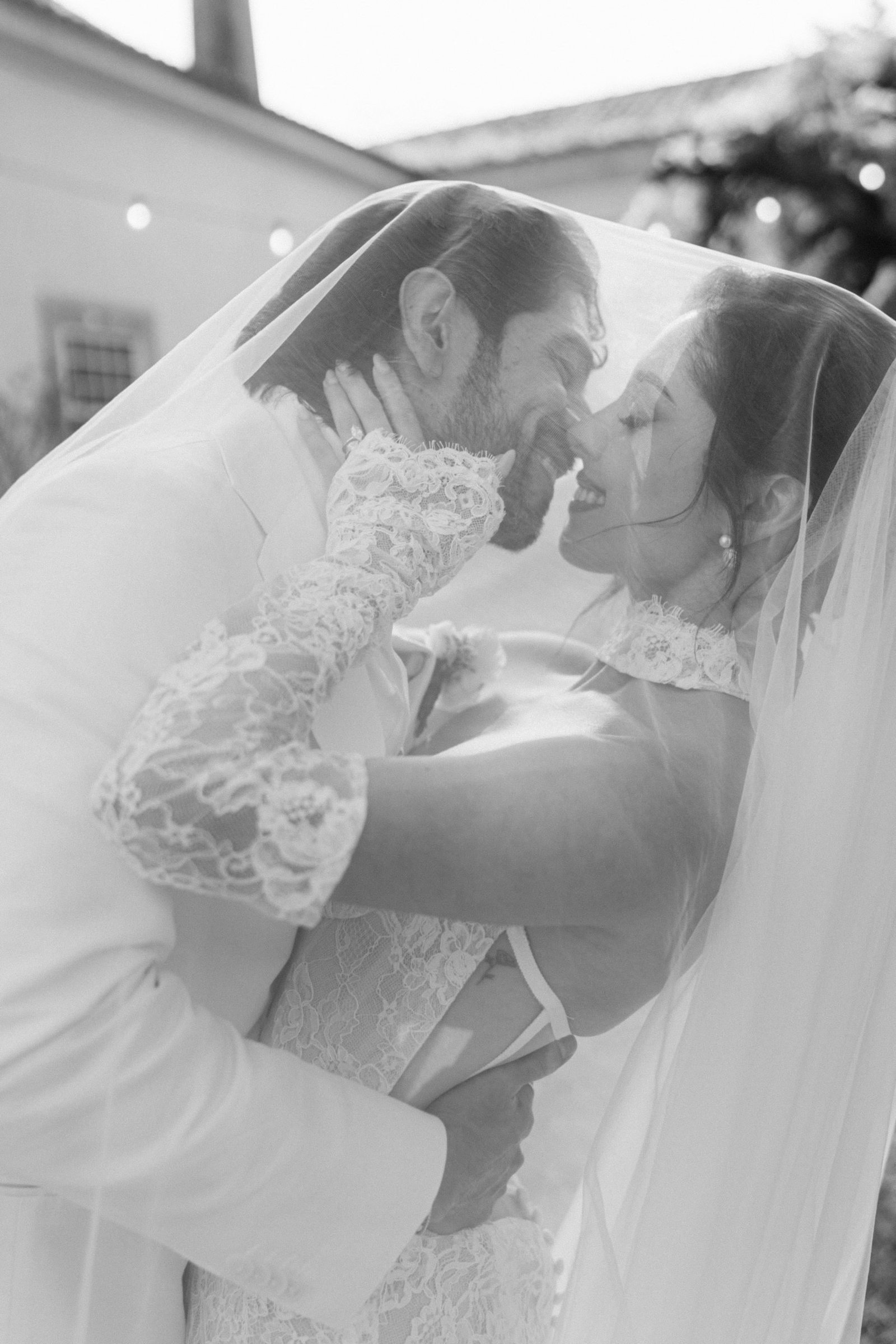 Black and white wedding portrait of bride and groom embracing — documentary wedding photography in Portugal by Flavia Grandi