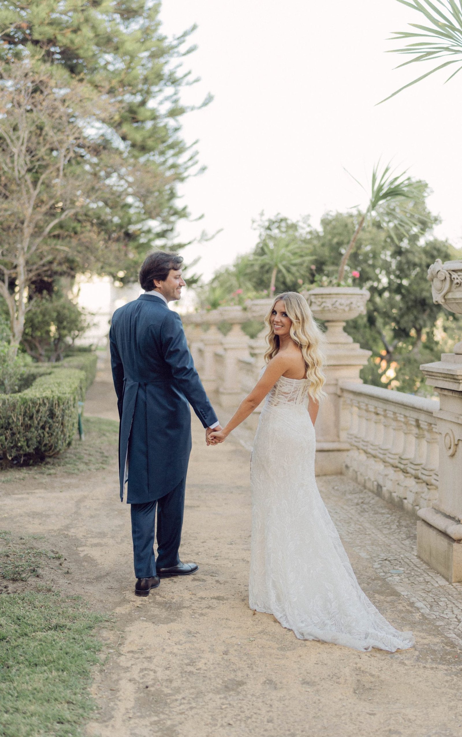 Bride and groom walking together at Pestana Palace. A historic wedding venue — destination wedding photographer Flavia Grandi