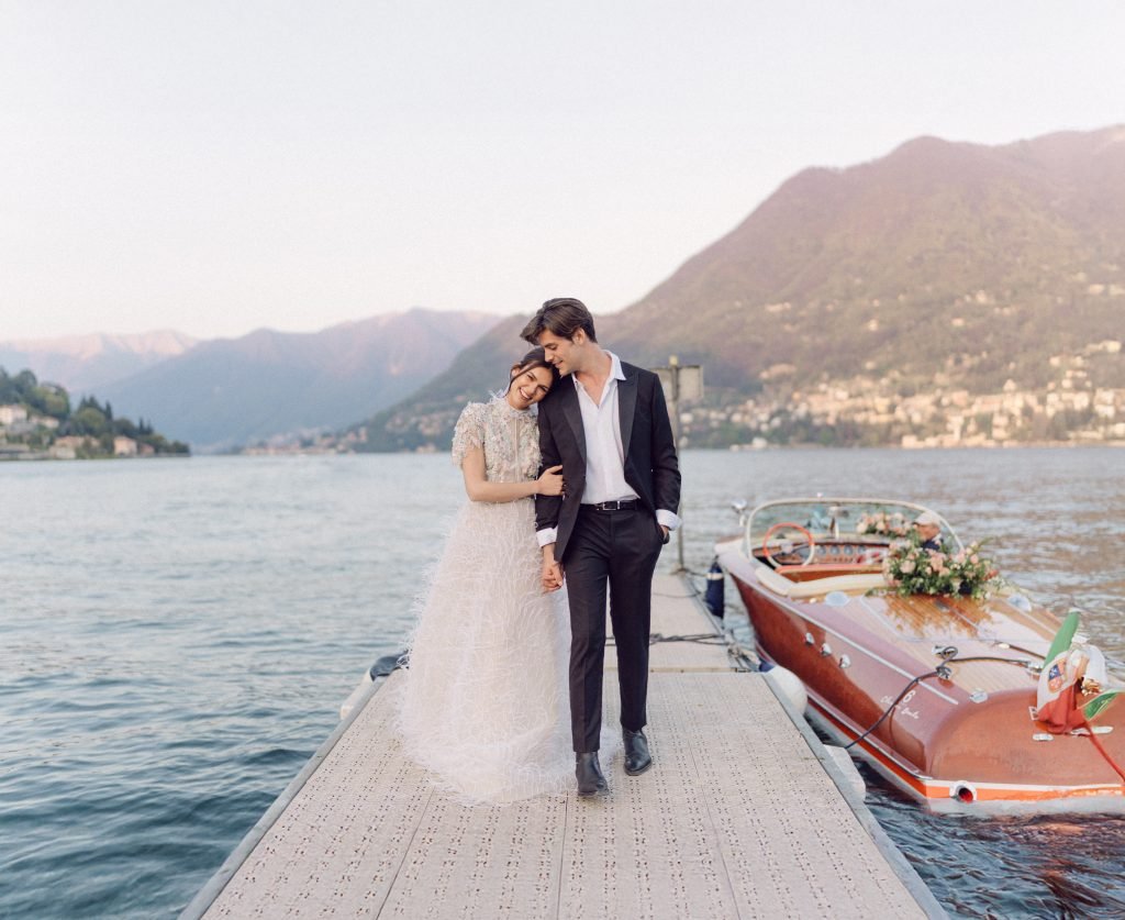 Bride and Groom walking holding hands at Lake Como Italy by Flavia Grandi - Italy Destination Wedding Photographer