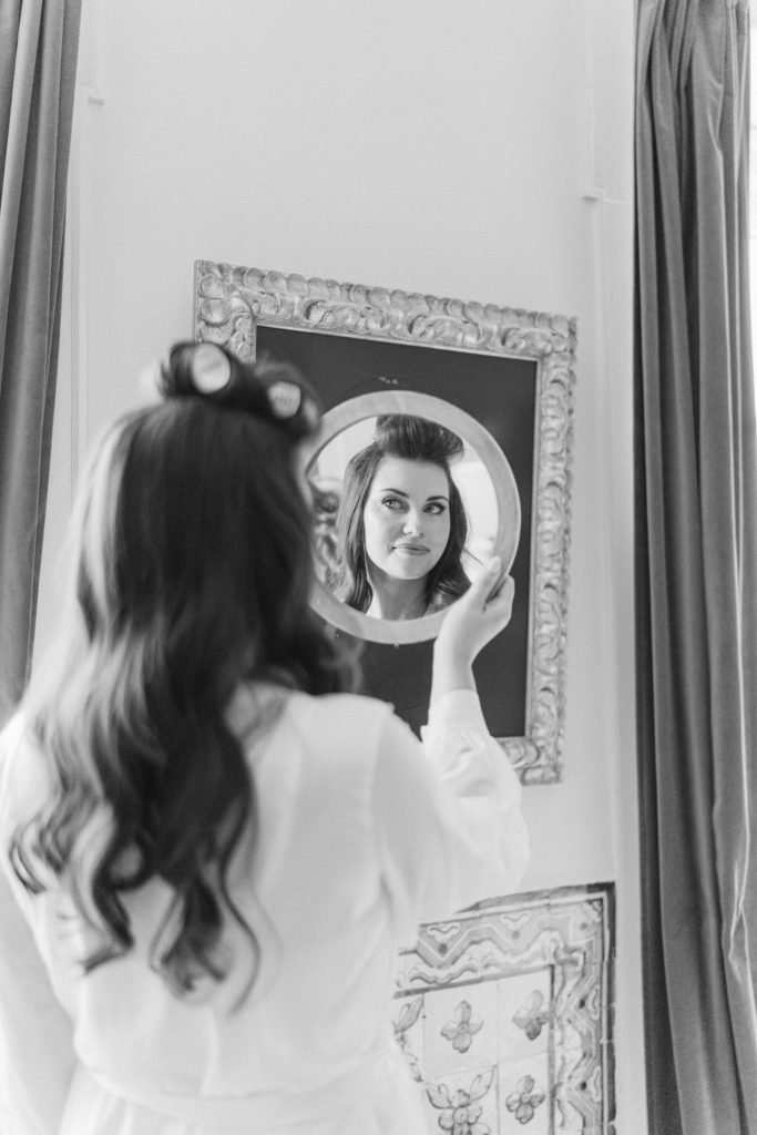 Bride looking in mirror before Vandelli Botanical Garden wedding
