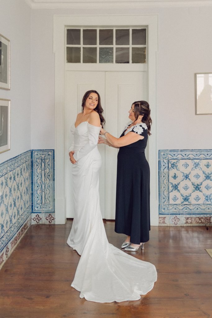 Bride having wedding dress fitted before ceremony