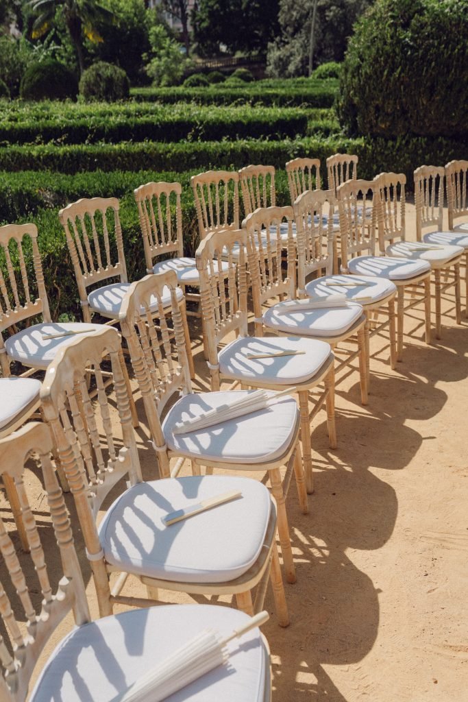 Wedding ceremony seating with parasols at Vandelli Botanical Garden