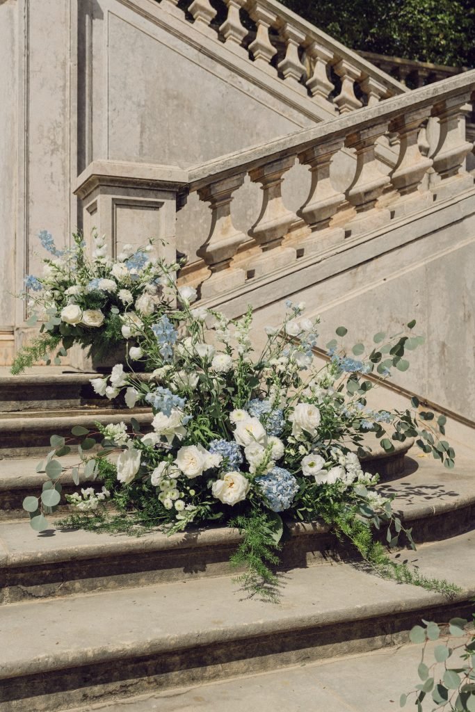 Wedding floral arrangements on historic stone staircase in Lisbon