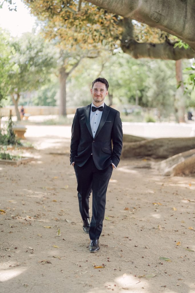 Groom portrait in black tuxedo at Vandelli Botanical Garden