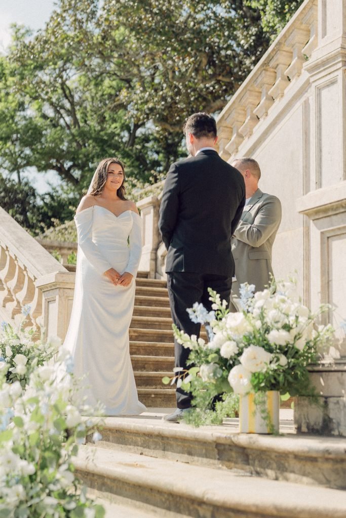 Bride smiling during outdoor ceremony at Vandelli Botanical Garden